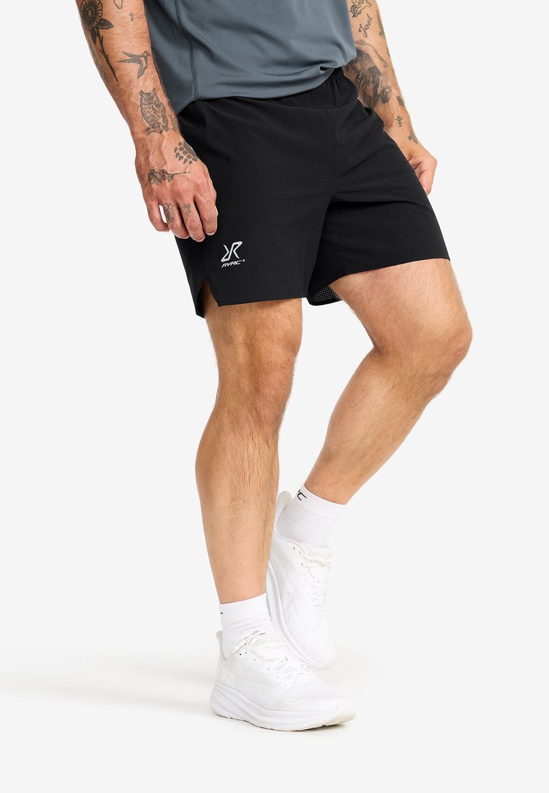 Black athletic shorts made of lightweight fabric, featuring a logo on the left hem, and side slits for added mobility.