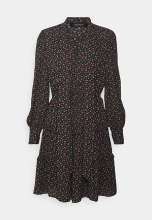 Schwarzes langärmliges Kleid mit kleinem pink- und grünem Blumenmuster, gerafften Bündchen und einem gestuften Rock.