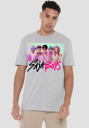 Gray cotton t-shirt featuring a colorful graphic of six characters with various hairstyles and the text "SAJA BOYS" in bold pink and black.