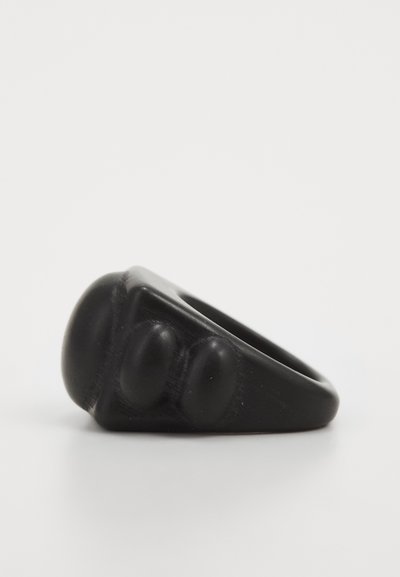 Black rubber ring featuring a rounded top with three prominent raised bumps, smooth texture, and a wide band.