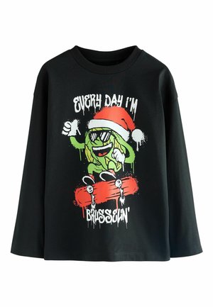 Schwarzes langärmliges T-Shirt mit einem bunten Grafikmotiv eines grünen Charakters in Sonnenbrille und Weihnachtsmannmütze, der auf einem roten Skateboard fährt.