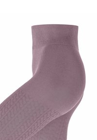 Leggings lilla chiaro con un design texturizzato lungo il lato, realizzati in un materiale morbido e elasticizzato. Finitura liscia e forma aderente.