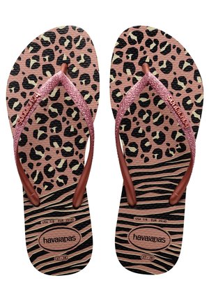 Rosa leopardmönstrade flip-flops med glittriga rosguldiga remmar. Texturerad svart och brunrandig fotbädd. Varumärket "havaianas" synligt.