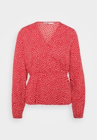 Blusa rossa con maniche lunghe, scollo a V, arricciatura in vita e piccolo stampa di cuori bianchi su tutto. Tessuto morbido e leggero.