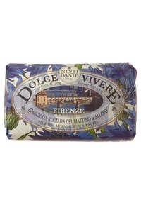 Nest Dante Firenze soap bar features a floral design with blue irises, wrapped in paper with a landscape and gold accents.
