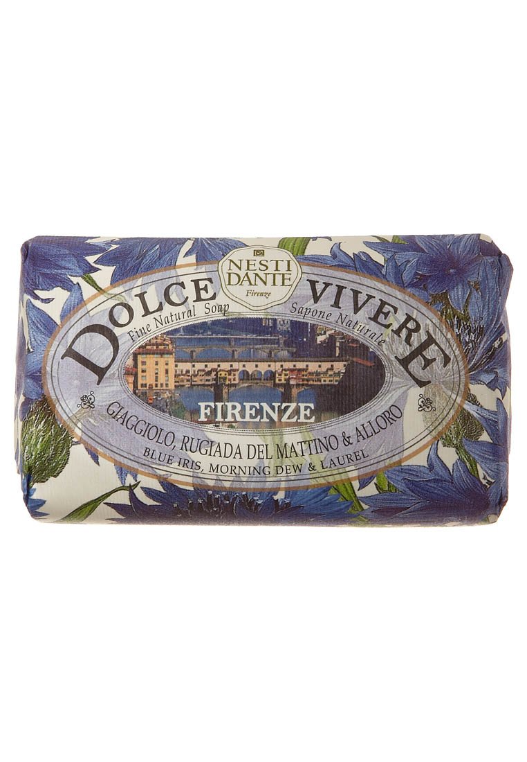 Nest Dante Firenze soap bar features a floral design with blue irises, wrapped in paper with a landscape and gold accents.