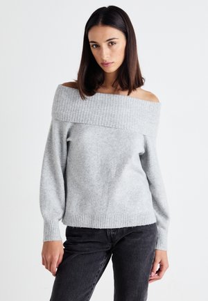 Light gray off-the-shoulder sweater with ribbed neckline, long sleeves, and soft texture, paired with dark jeans.