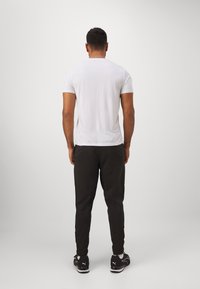 Puma TAD ESSENTIALS SOLID CAT TEE  - Αθλητικό μπλουζάκι - white