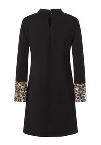 Schwarzes Kleid mit hohem Ausschnitt und langen Ärmeln. Die Manschetten haben einen glänzenden goldenen und blauen Leopardenmuster-Akzent. Schlüsselrücken mit zwei Knöpfen.