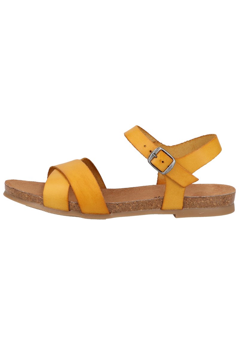 Gelbe Leder-Sandale mit Überkreuzriemen und verstellbarem Knöchelriemen. Korkfußbett und flache Gummisohle für Komfort.