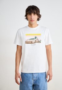 White cotton t-shirt featuring a graphic print of a car and figure, bordered by horizontal pastel stripes in pink and yellow.