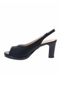 Chaussure femme noire à bout ouvert et bride arrière, talon moyen épais et empeigne en tissu sur fond blanc.