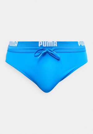 Slip de bain pour homme bleu vif avec une ceinture bleue et des logos "PUMA" blancs, avec un cordon de serrage bleu noué au centre devant.