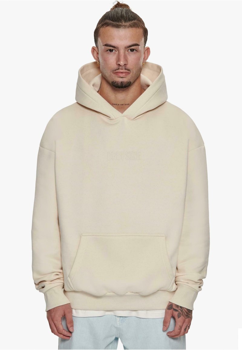 Cream-colored hooded sweatshirt with a front pocket, relaxed fit, and ribbed cuffs. Features embossed "DROPSIZE" logo on the chest.