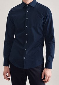 Camicia a maniche lunghe blu navy in tessuto liscio, con colletto classico, chiusura a bottoni e leggero luccichio.
