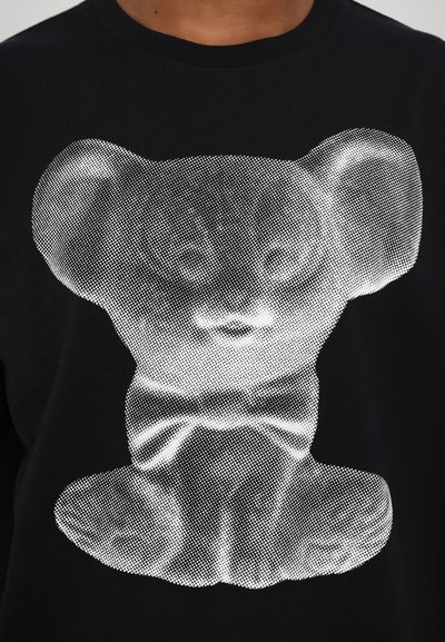 Black t-shirt featuring a white, dotted graphic of a bear with large ears, a bow tie, and detailed facial features.