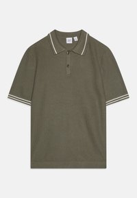 Alyvmedžio žalias polo marškinėliai su baltais dryžiais ant apykaklės ir rankovių; turi trių mygtukų užsegimą ir tekstūruotą audinį.