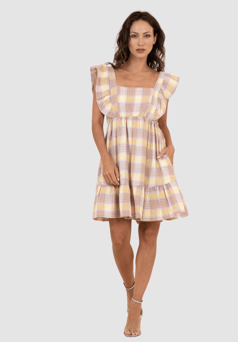 Vestido a cuadros en colores pastel con mangas con volantes, escote cuadrado y falda acampanada. La tela parece ligera y texturizada.