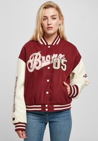 Maroon and cream varsity jacket with "Bronx" and "05" embroidered, featuring striped bands on collar and cuffs, and side pockets.