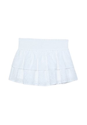 White tiered skirt made of embroidered cotton with a smocked waistband. Features layered ruffles and eyelet patterns throughout.