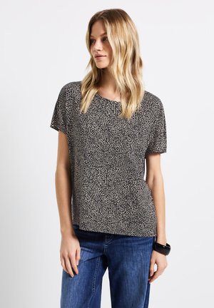 T-shirt à manches courtes en design imprimé animal noir et beige. Fabriqué en tissu léger avec une coupe décontractée et un col rond.