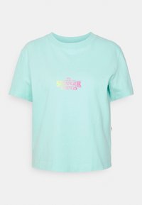 Mint green cotton t-shirt with a crew neckline. Features "STRANGER THINGS" logo in gradient pink to yellow. Short sleeves and boxy fit.