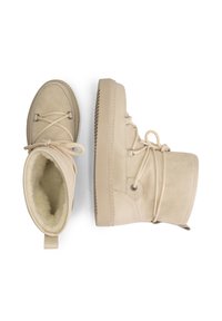 Beige winter boots with thick rubber soles, suede and leather upper, round toe, rope laces, and fleece lining visible inside one boot.