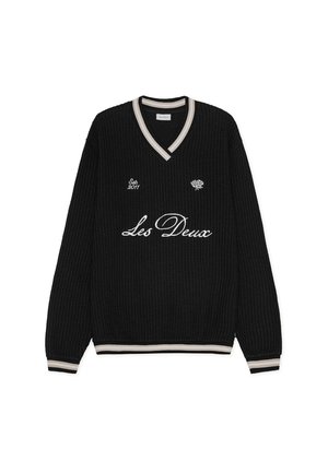 Suéter negro de tejido waffle con cuello en V, con puños y dobladillo a rayas en blanco y beige. Logo bordado en blanco en la parte delantera.