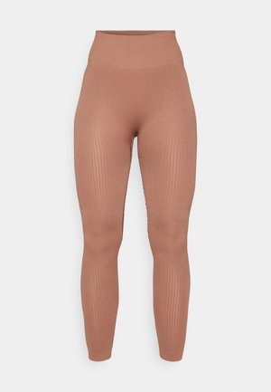 Ribbet højtaljede leggings i en varm, afdæmpet brun farve. Fremstillet af strækbart materiale, der har en tætsiddende pasform og glat tekstur.