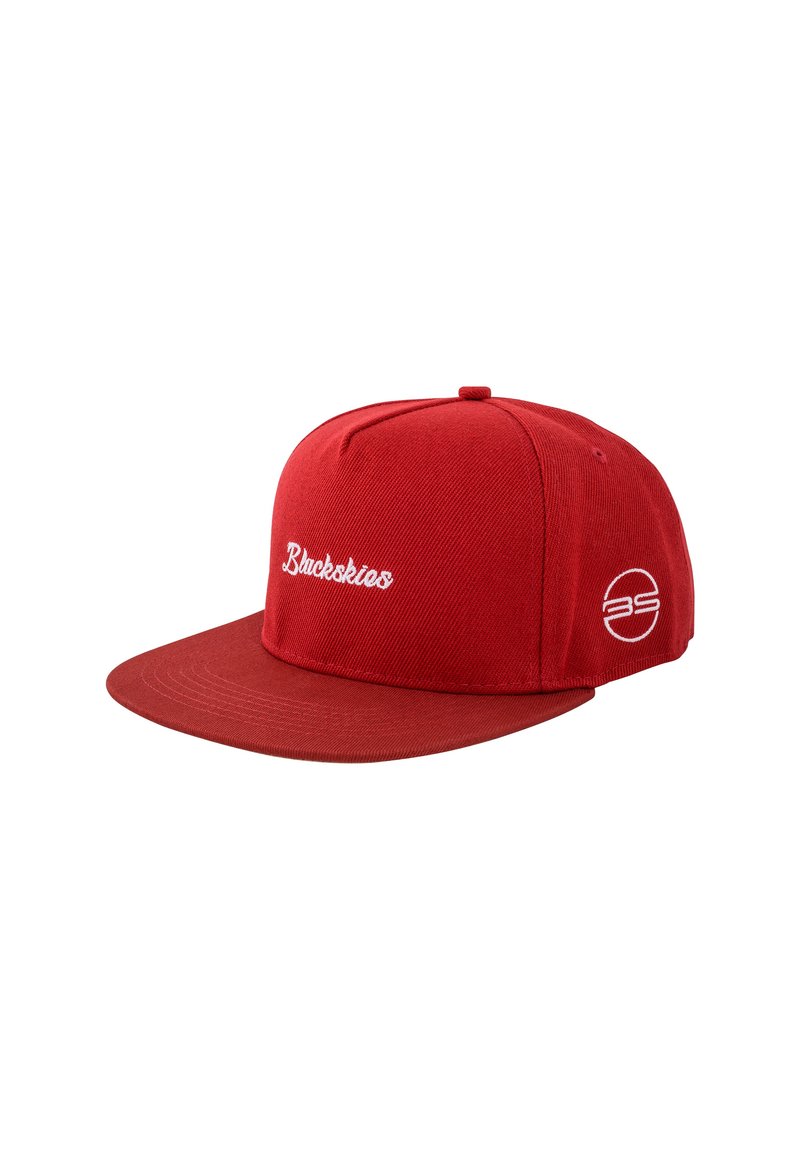 Red snapback cap made of textured fabric. Features white embroidered text and logo. Flat visor with stitching details, side ventilation holes.