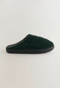 Pantofole verde in corduroy con design trapuntato, interno in pile grigio e suola in gomma nera. Texture liscia con forma slip-on.