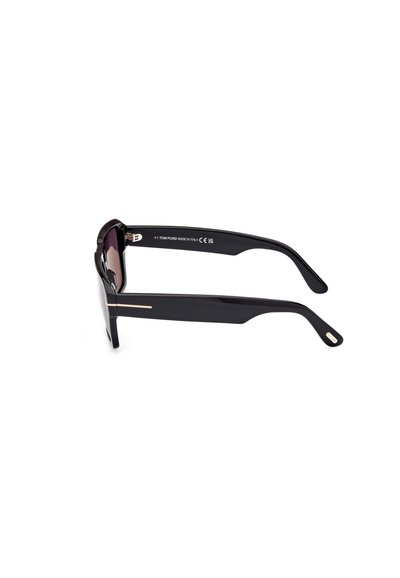 Black sunglasses with a sleek, angular design. Features dark tinted lenses and gold detailing on the sides. Made in Italy.