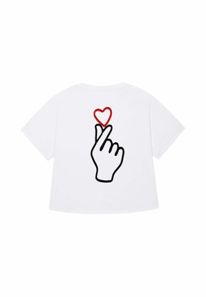 White t-shirt featuring a black outline of a hand making a gesture with a red heart above it, symbolizing love or affection.