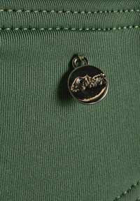 Green textured fabric featuring fine ribbing, with a gold metal tag inscribed "s.Oliver" attached by a small loop.