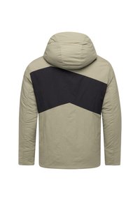 Hoodiejacka i ljusbeige med en kontrasterande svart chevron-design över ryggen. Slätt material med en mjuk yta.