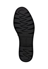 Black rubber shoe sole featuring curved patterns and grooves for traction, with a smooth central area and embossed branding detail.