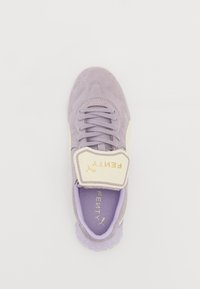 Purple suede sneaker with a cream strap featuring gold logo, lace-up design, textured upper, and translucent sole.