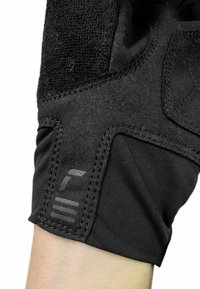 Black glove featuring a blend of textured fabric and smooth material. Notable details include padded sections and a brand logo on the cuff.