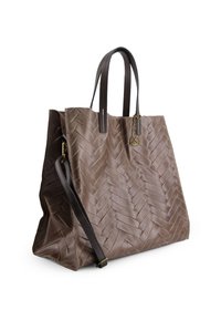 Brown suede tote bag with a woven texture, dual flat handles, and an optional leather shoulder strap. Features a gold charm accessory.