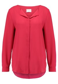 Blusa a maniche lunghe di un brillante color rosa, realizzata in tessuto morbido. Presenta una chiusura con bottoni frontale, un scollo a V e un orlo leggermente arrotondato.