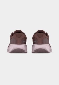 Pair of brown and light pink athletic shoes shown from the back on a white background, highlighting textured mesh and sole details.