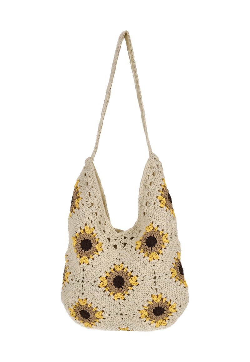 Koukkuukoukattu käsilaukku kermanvärisenä, jossa on keltaisia ja ruskeita auringonkukkakuoseja. Laukussa on rento muoto ja yksi olkahihna.