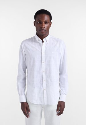 Weißes Hemd zum Knöpfen mit einem strukturierten Gittermuster, ausgestattet mit einem klassischen Kragen und langen Ärmeln. Hergestellt aus leichtem Stoff.
