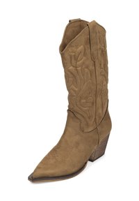 Bota de vaquero de ante marrón con punta afilada, diseño floral grabado y tacón de madera en ángulo. Presenta detalles cosidos cerca de la punta y la parte superior.