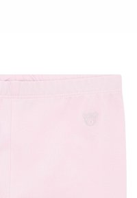 Leggings rosa chiaro con un elastico in vita e un piccolo logo a forma di orsetto argentato sul fronte, realizzati in morbido cotone misto.
