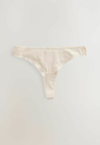 Katoenen string in crèmekleur. Heeft een soepele textuur, een dunne tailleband en kantdetails langs de randen. Een kleine strikaccent aan de voorkant.