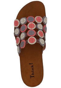 Sandal with a brown suede footbed, featuring colorful round leather accents in red, white, and purple arranged in a strappy design.