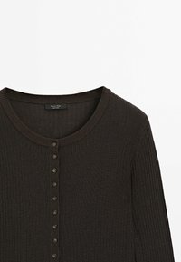 Brown ribbed cardigan featuring a rounded neckline and a row of small buttons down the front. Sweater texture is soft and knitted.