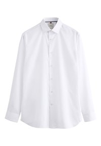 Chemise blanche à manches longues avec boutons, col pointu et poignets, présentée à plat sur un fond blanc.