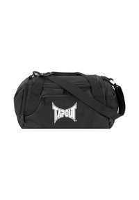 Bolsa de deporte negra hecha de un tejido duradero, con un gran logo blanco de TAPOUT, correa ajustable, compartimentos con doble cremallera y asas resistentes.